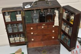 AN EARLY 19TH CENTURY MAHOGANY APOTHECARY'S CABINET, with brass swan neck carrying handle to the top