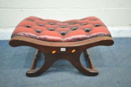 AN OXBLOOD BUTTONED LEATHER CROSS FRAMED FOOTSTOOL (condition report: surface scratches)