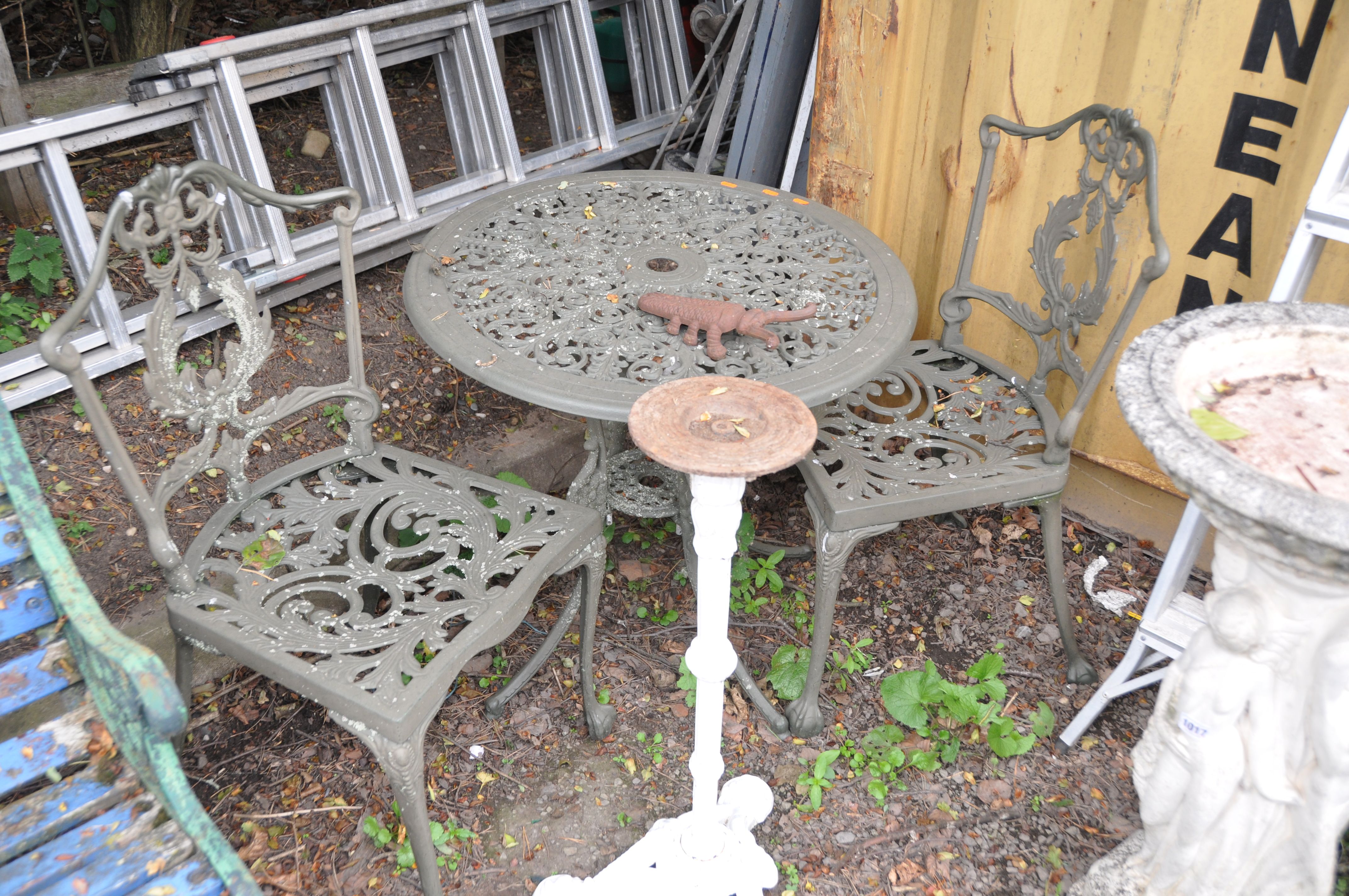 A MODERN CIRCULAR CAST ALUMINIUM GARDEN TABLE 69cm in diameter with two matching chairs, a Scarab