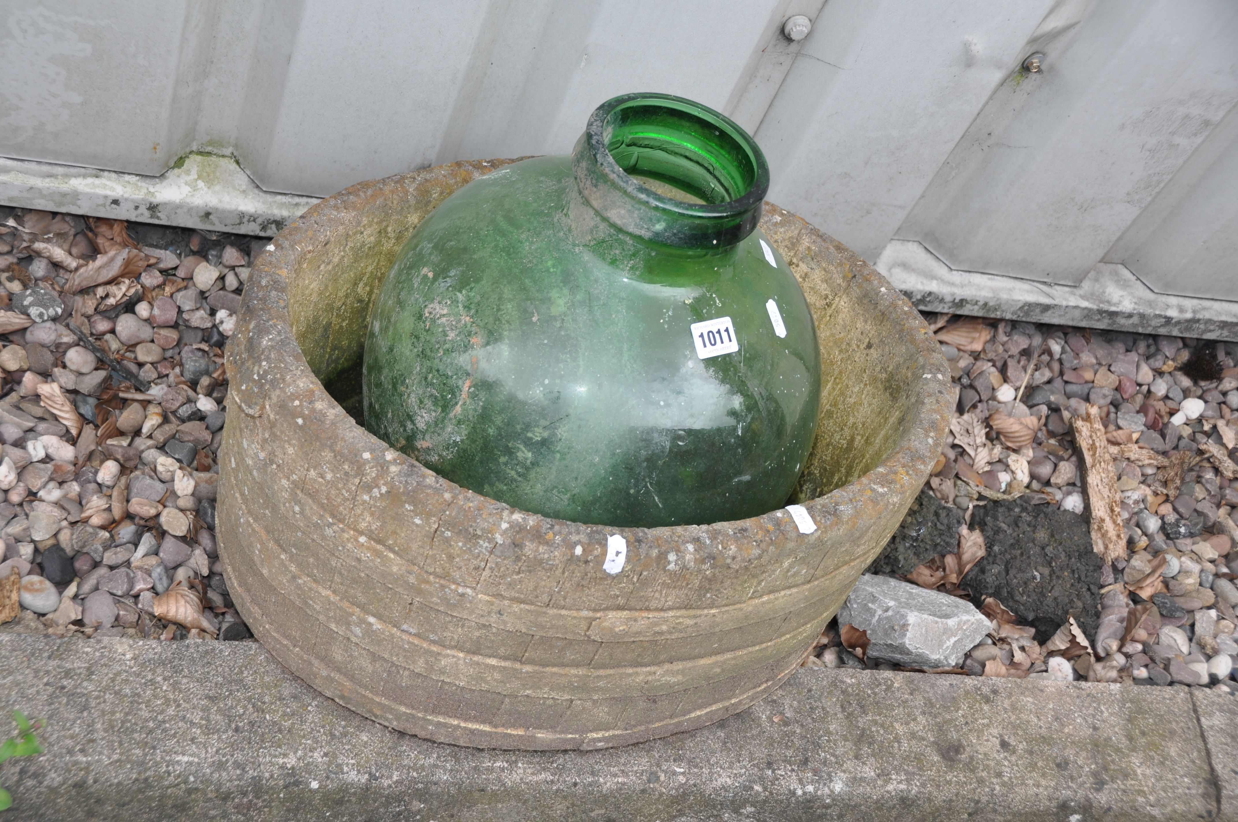 A MODERN COMPOSITE BARREL EFFECT OVAL PLANTER width 52cm depth 33cm height 24cm and a green glass