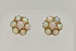 A PAIR OF GOLD OPAL CLUSTER EAR STUDS, designed as seven circular opal cabochons claw set in a