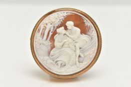 A 9CT GOLD CAMEO BROOCH, of a circular form, carved shell cameo depicting a couple scene, collet set