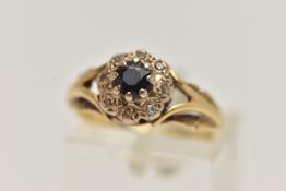 AN 18CT GOLD SAPPHIRE AND DIAMOND CLUSTER RING, designed as a central circular sapphire within a