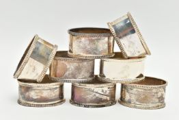 A SET OF EIGHT ELIZABETH II OVAL SILVER NAPKIN RINGS, fluted rims, all engraved with initial 'A',