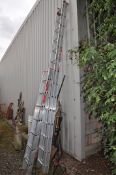 A SET OF ALUMINIUM DOUBLE EXTENSION LADDERS with fourteen rungs to each 390cm length and another