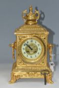 AN EARLY 20TH CENTURY GILT METAL MANTEL CLOCK, the rectangular case with twin handled finial on a