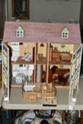 A MODERN KIT BUILT WOODEN DOLLS HOUSE, front opening to reveal four rooms over two floors with