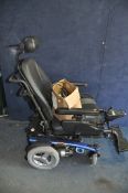 A PRIDE MOBILITY ARTEMIS ELECTRIC WHEELCHAIR with headrest, two footrests, charger and manual (PAT