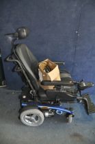 A PRIDE MOBILITY ARTEMIS ELECTRIC WHEELCHAIR with headrest, two footrests, charger and manual (PAT