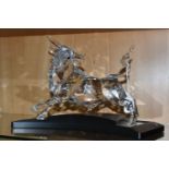 A CASED SWAROVSKI CRYSTAL LIMITED EDITION CLEAR BULL SCULPTURE, numbered 5906/10000 to underside,