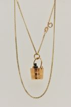 A 9CT GOLD PENDANT AND CHAIN, the pendant in the form of a champagne bucket with a plastic champagne