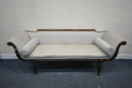 A REGENCY WALNUT SCROLLED SOFA, on reeded decoration, on square tapered legs, and brass casters,