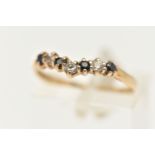 A 9CT GOLD CUBIC ZIRCONIA WISH BONE RING, set with a row of blue and colourless cubic zirconia, to a