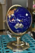 A MODERN TABLE TOP TERRESTRIAL GLOBE, mounted in a brass gimbal stand / frame, height 36cm