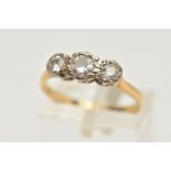 A YELLOW METAL THREE STONE DIAMOND RING, round brilliant cut diamond to the centre, flanked with two