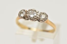A YELLOW METAL THREE STONE DIAMOND RING, round brilliant cut diamond to the centre, flanked with two