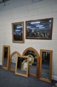 SEVEN VARIOUS PINE FRAMED WALL MIRRORS, of various shapes, largest mirror 104cm x 73cm (condition