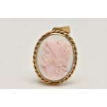 A CARVED CAMEO PENDANT, the oval conch shell carved to depict a male soldier in profile within a