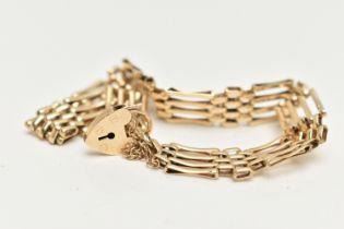 A 9CT GOLD GATE BRACELET, four bar gate bracelet, fitted with a heart padlock clasp, with additional