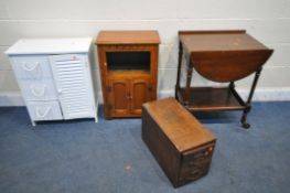 AN OAK TWO DOOR CABINET, along with an oak two drawer index cabinet, oak oval drop leaf trolley, and