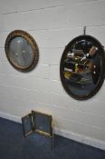 A GILT CIRCULAR WALL MIRROR, with foliate design to frame, diameter 62cm, a mahogany oval mirror,