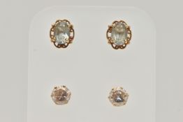 TWO PAIRS OF EAR STUDS, the first designed as an oval blue topaz within a four claw setting with a
