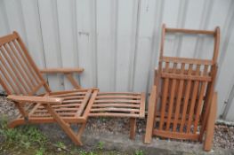 A PAIR OF FOLDING HARDWOOD GARDEN LOUNGERS with leg rests (2)