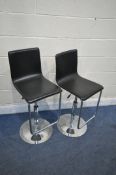 A PAIR OF BLACK SWIVEL HIGH STOOLS (scuff to front right corner of one chair) (2)