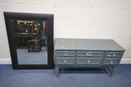 A BROWN LEATHER BEVELLED EDGE WALL MIRROR, 86cm x 118, along with a painted sideboard/chest of six