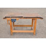 A LARGE AND HEAVY WORKBENCH with a recess to wooden woodworking top and two hinged lids for