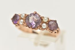 A YELLOW METAL AMETHYST AND SEED PEARL RING, designed with three circular cut amethysts, each claw