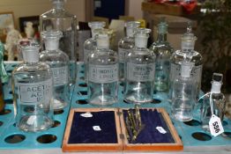 ELEVEN CLEAR GLASS CHEMIST /PHARMACY BOTTLES AND AN INCOMPLETE DRAUGHTSMAN'S SET, seven of the