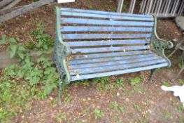 A MODERN CAST IRON ENDED GARDEN BENCH with wooden slatted back and seat, ends have ornate pierced