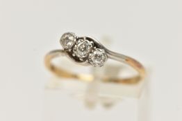 A YELLOW METAL THREE STONE DIAMOND RING, asymmetrical row of three old cut diamonds, white metal