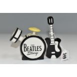 A LORNA BAILEY 'THE BEATLES STORY' SMALL TEA POT IN THE FORMOF A DRUM KIT AND GUITAR, signed to