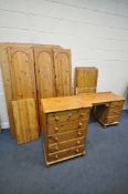 A PINE BEDROOM SUITE, comprising a triple door wardrobe, width 137cm x depth 57cm x height 179cm,