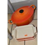 THREE PIECES OF LE CREUSET COOKWARE, comprising an oval cast iron covered casserole dish, size 25,