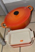 THREE PIECES OF LE CREUSET COOKWARE, comprising an oval cast iron covered casserole dish, size 25,