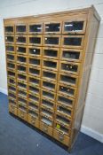 AN EARLY 20TH CENTURY HABERDASHERY CABINET, made up of eighty drawers with glass fronts, and five
