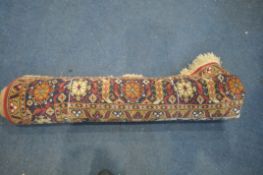A LARGE WOOLLEN PERSIAN FLORAL PATTERNED RUG, with a red and cream field, 360cm x 250cm (condition
