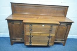 A WYLIE AND LOCHHEAD ARTS AND CRAFTS OAK BREAKFRONT SIDEBOARD, with a later raised back, panelled