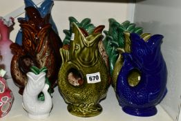 A COLLECTION OF FIFTEEN 'GLUGGLE' FISH JUGS, mainly by Dartmouth Pottery, in greens, blue, brown and