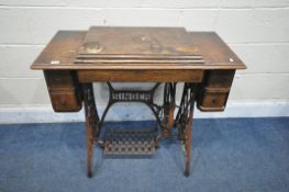 A VINTAGE SINGER TREADLE SEWING MACHINE (condition report: the top surface with water stains and