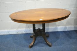 AN EDWARDIAN WALNUT AND INLAID OVAL TILT TOP LOO TABLE, on four turned supports and shaped legs,