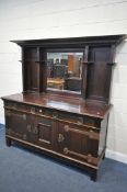 AN ARTS AND CRAFTS MAHOGANY MIRRORBACK SIDEBOARD, the bevelled edge mirror back above a base with