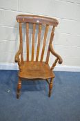A VICTORIAN ELM AND BEECH ARMCHAIRM with open armrests, on turned legs, united by a H stretcher (
