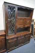 A JAYCEE OAK LINENFOLD DISPLAY UNIT, with an arrangement of cupboards and drawers, width 142cm x