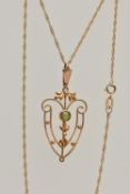 AN EDWARDIAN PENDANT AND CHAIN, open work floral pendant, set with a circular cut peridot, missing