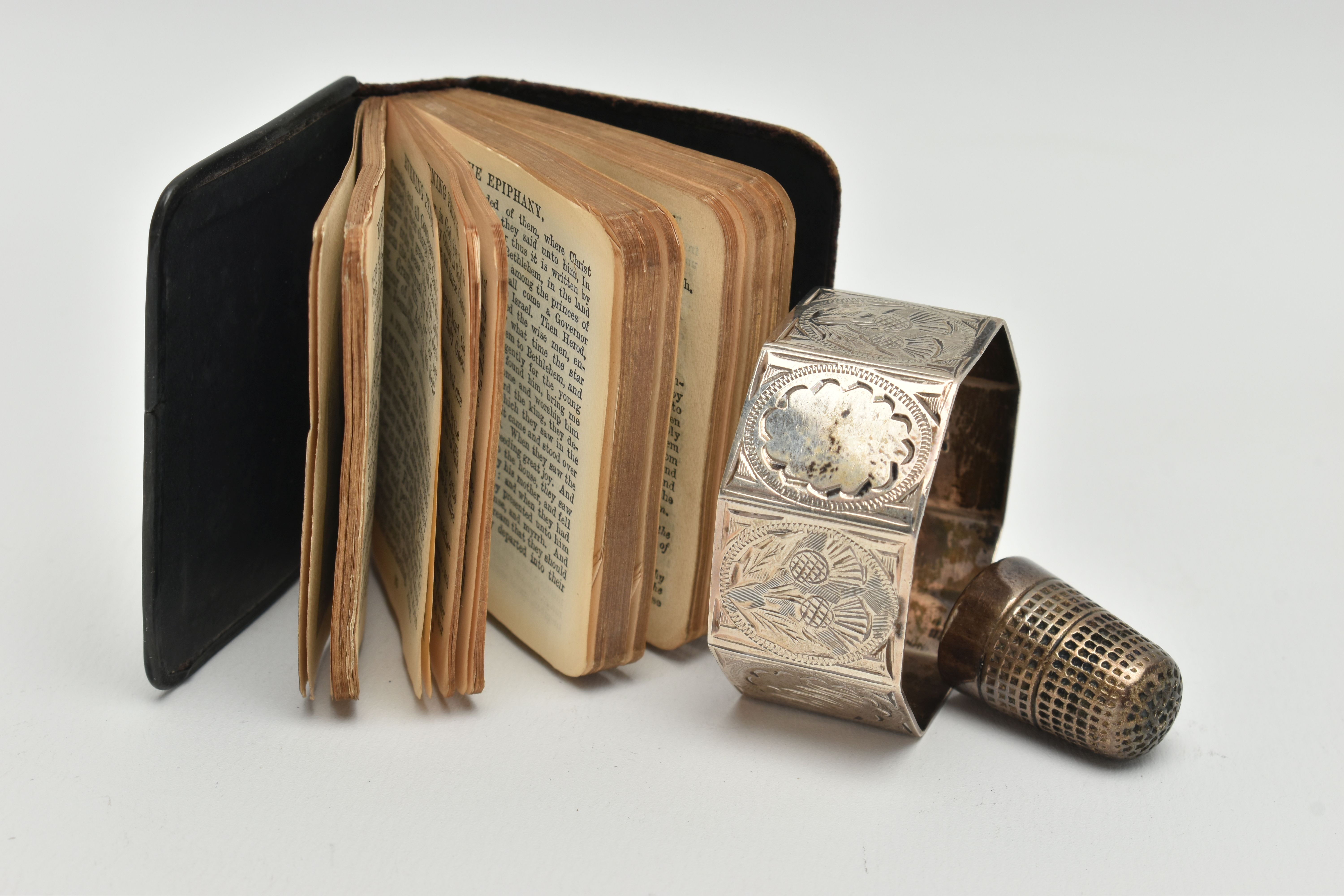 A MINIATURE BIBLE, THIMBLE AND A NAPKIN RING, silver embossed cherub front to the bible hallmarked - Image 2 of 3