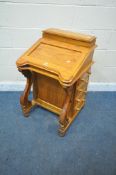 A REPRODUCTION PINE DAVENPORT, with a hinged lid and storage compartment, and four drawers to